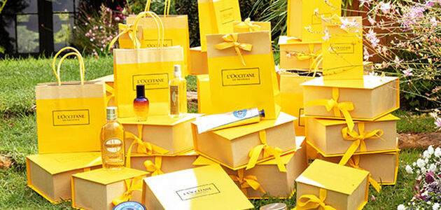 l'occitane yellow gift bags with best sellers on grass